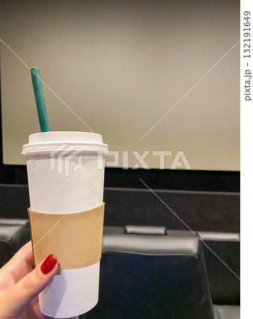 Coffee Cup in Cinema Hall Before Movie Start Coffee Cup in Cinema Hall Before Movie Start 132191649