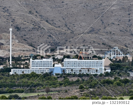 A Scenic View of a Hotel Elegantly Surrounded by Majestic Mountains and Lush Nature 132193012