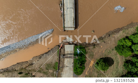 Aerial view of a broken bridge in Doi Hang subdistrict after Typhoon Yagi has swept Chiang Rai province of Thailand. 132193526