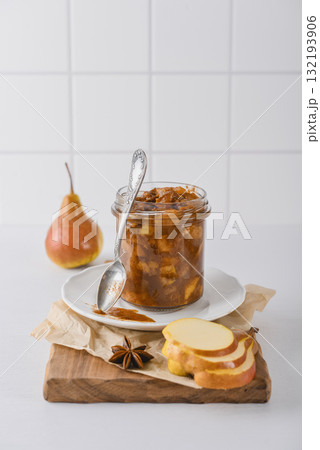 Pear jam in a glass jar with ripe pears 132193906