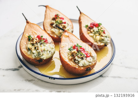 Delicious baked pears with nuts, blue cheese, thyme, cranberry and honey Delicious baked pears with nuts, blue cheese, thyme, cranberry and honey 132193916