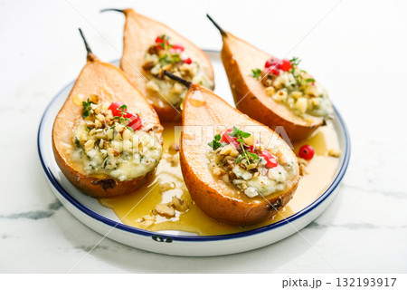 Delicious baked pears with nuts, blue cheese, thyme, cranberry and honey 132193917