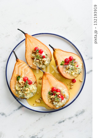 Delicious baked pears with nuts, blue cheese, thyme, cranberry and honey Delicious baked pears with nuts, blue cheese, thyme, cranberry and honey 132193919