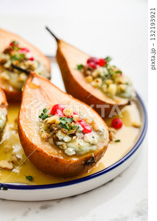 Delicious baked pears with nuts, blue cheese, thyme, cranberry and honey 132193921