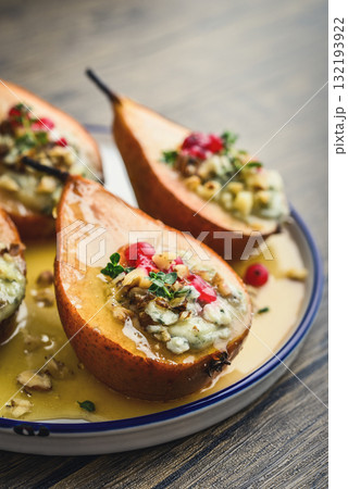 Delicious baked pears with nuts, blue cheese, thyme, cranberry and honey Delicious baked pears with nuts, blue cheese, thyme, cranberry and honey 132193922