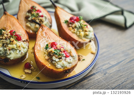 Delicious baked pears with nuts, blue cheese, thyme, cranberry and honey 132193926