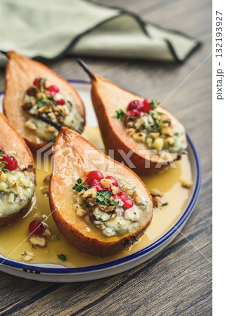 Delicious baked pears with nuts, blue cheese, thyme, cranberry and honey 132193927