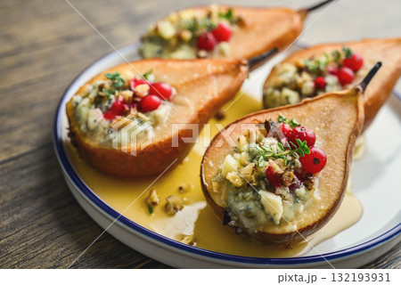 Delicious baked pears with nuts, blue cheese, thyme, cranberry and honey Delicious baked pears with nuts, blue cheese, thyme, cranberry and honey 132193931