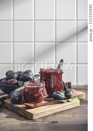 Plum jam in glass jars with ripe plums 132193940