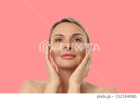 Woman gently massaging cream into her skin for hydration Woman gently massaging cream into her skin for hydration 132194080