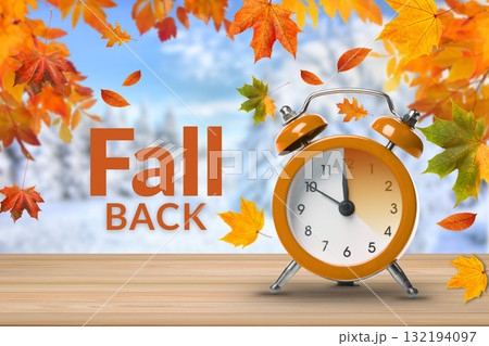 Orange clock with autumn leaves in a bright scene Orange clock with autumn leaves in a bright scene 132194097