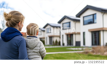 Caucasian Mother and child observing modern suburban homes Caucasian Mother and child observing modern suburban homes 132195522