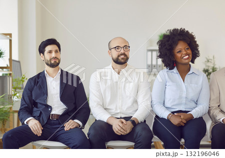 Multicultural group of business people sitting in a row, close-up 132196046