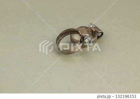 Metal clamps and rings on a plain background in a workshop setting Metal clamps and rings on a plain background in a workshop setting 132196151