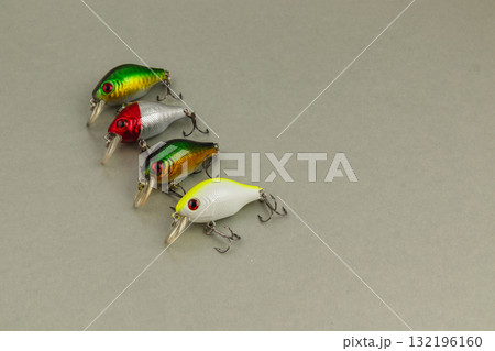 Colorful fishing lures arranged neatly on a smooth surface 132196160
