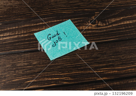 Positive message on a sticky note placed on a wooden table Positive message on a sticky note placed on a wooden table 132196209