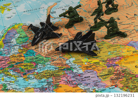 Military toys on a world map highlighting strategic locations Military toys on a world map highlighting strategic locations 132196231