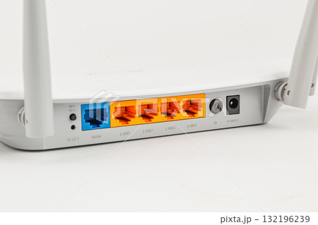 Wireless router back panel with multiple Ethernet ports and power connection 132196239