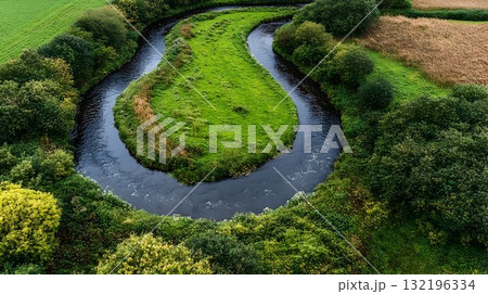 Aerial view of river bends through lush green landscape 132196334