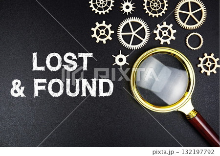 Lost And Found text message with magnifying glass on black background 132197792