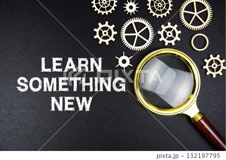 Learn Something New text message with magnifying glass on black background Learn Something New text message with magnifying glass on black background 132197795