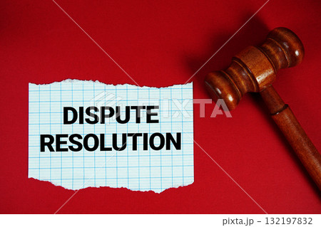 Dispute Resolution text written on rip paper with wooden judgment gavel on red background Dispute Resolution text written on rip paper with wooden judgment gavel on red background 132197832