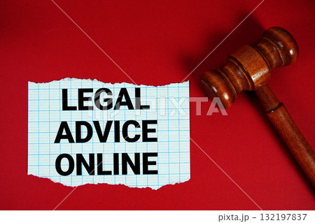 Legal Advice Online text written on rip paper with wooden judgment gavel on red background Legal Advice Online text written on rip paper with wooden judgment gavel on red background 132197837