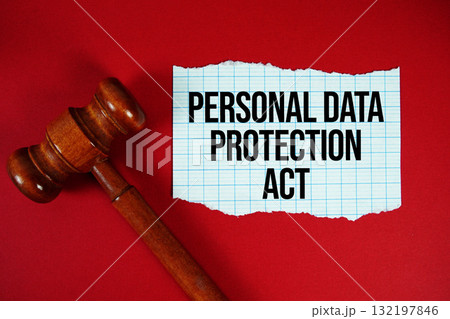 Personal Data Protection Act text written on rip paper with wooden judgment gavel on red background 132197846
