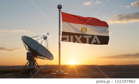 Egyptian flag waving beside a satellite dish at sunset in a field view scene 132197962