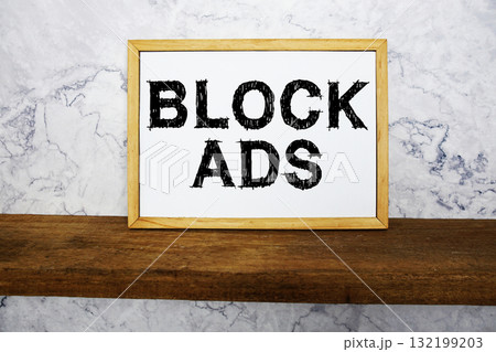 Block Ads text written on whiteboard with wooden shelf and marble background Block Ads text written on whiteboard with wooden shelf and marble background 132199203