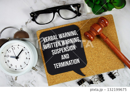 Verbal Warning, Written Warning, Suspension and Termination text on speech bubble with alarm clock and wooden gavel on marble background 132199675
