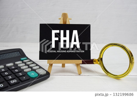 FHA abbreviation of Federal Housing Administration text with magnifying glass and calculator on wooden background FHA abbreviation of Federal Housing Administration text with magnifying glass and calculator on wooden background 132199686