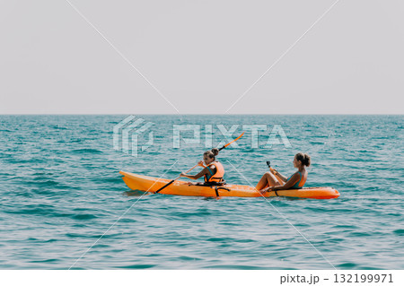 Two Women Kayaking on a Sunny Day Two Women Kayaking on a Sunny Day 132199971