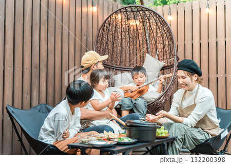 ウッドデッキで食事するファミリー（グランピング,アウトドア,別荘,コテージ） 132200398