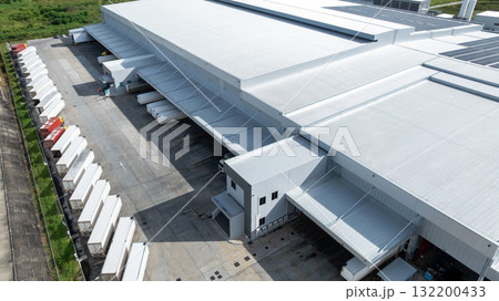 Aerial view modern warehouse for trucks unloading and loading, semi truck cargo trailer at logistic park warehouse, Distribution warehouse shipping supply chain, Business transportation logistic. Aerial view modern warehouse for trucks unloading and loading, semi truck cargo trailer at logistic park warehouse, Distribution warehouse shipping supply chain, Business transportation logistic. 132200433