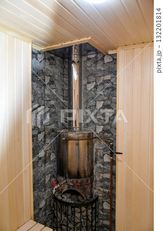 Interior of a traditional steam bath (sauna) with a wood-burning stove Interior of a traditional steam bath (sauna) with a wood-burning stove 132201814
