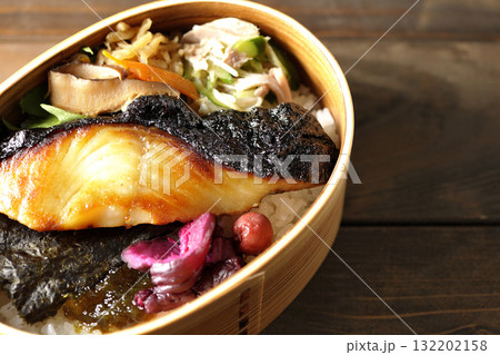 曲げわっぱに入っていて銀鱈の西京焼が乗っている海苔弁当 132202158