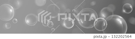 Soap bubbles flying on gray background Soap bubbles flying on gray background 132202564
