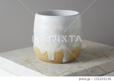 Close up ceramic cup on gray background Close up ceramic cup on gray background 132203236