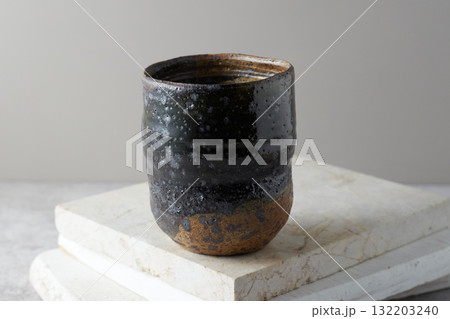 Close up ceramic cup on gray background Close up ceramic cup on gray background 132203240