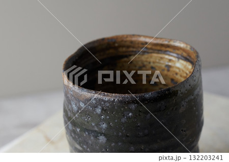 Close up ceramic cup on gray background Close up ceramic cup on gray background 132203241