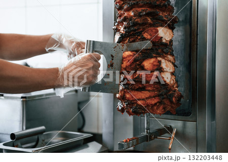 Chef preparing and making traditional Turkish Doner Kebab meat. Shawarma or gyros Chef preparing and making traditional Turkish Doner Kebab meat. Shawarma or gyros 132203448