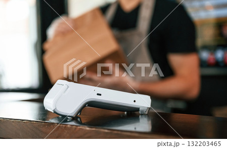 Payment by using terminal, order is ready. Man is serving delicious street food Payment by using terminal, order is ready. Man is serving delicious street food 132203465