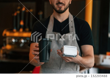 Drink and terminal for payment are ready. Man is serving delicious street food Drink and terminal for payment are ready. Man is serving delicious street food 132203488