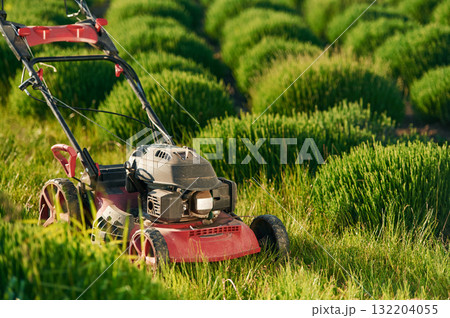Lawn mower on the green field Lawn mower on the green field 132204055