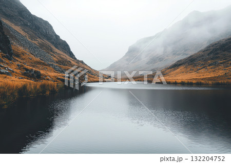 serene lake surrounded by misty mountains, soft grey tones, and crisp reflections create tranquil atmosphere serene lake surrounded by misty mountains, soft grey tones, and crisp reflections create tranquil atmosphere 132204752