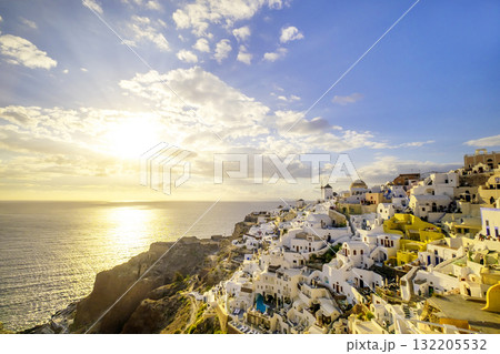 Oia village, Santorini, Greece. sunset view of traditional houses in Santorini. Small narrow streets and rooftops of houses, churches and hotels. Landscape Oia village, Santorini, Greece. sunset view of traditional houses in Santorini. Small narrow streets and rooftops of houses, churches and hotels. Landscape 132205532