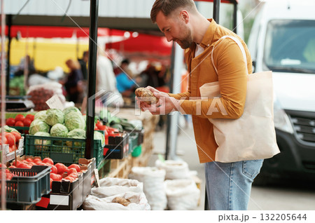 Handsome man is on the street market or bazaar 132205644