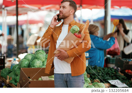 Handsome man is on the street market or bazaar 132205684