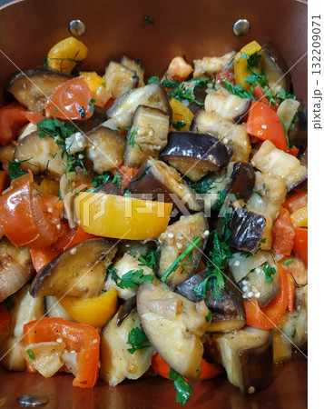Eggplant, tomatoes, and peppers sauteed with herbs in a pan healthy vegan dinner 132209071
